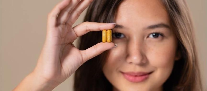 Woman Holding Vitamin Pills